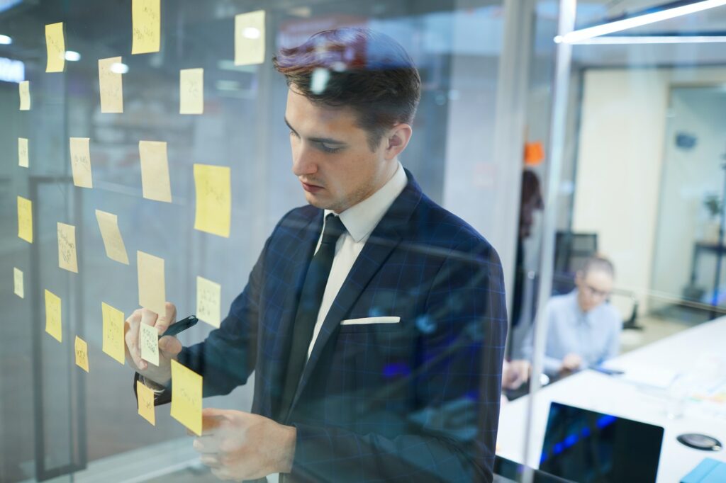 Businessman writing his plans at office